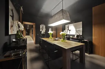 a kitchen with a wooden table and black walls at Parioli Place B&B in Rome