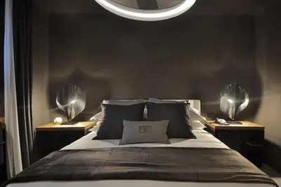 a bedroom with a large bed with two night stands at Parioli Place B&B in Rome