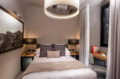 a bedroom with a bed with two tables and a light at Parioli Place B&B in Rome