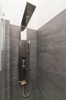 a shower with a glass door and a shower head at Room 91-S. Peter in Rome