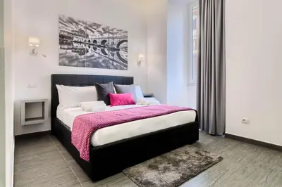 a bedroom with a large bed with a pink blanket at Room 91-S. Peter in Rome
