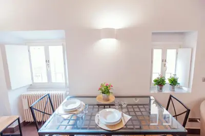 a dining room with a glass table and chairs at Domizio in Rome