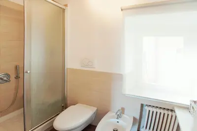 a bathroom with a shower and a toilet and a sink at Domizio in Rome