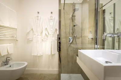 a white bathroom with a sink and a shower at Old Town Apartments Rome in Rome