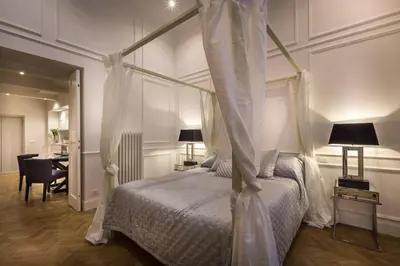 a bedroom with a canopy bed and a desk at Old Town Apartments Rome in Rome