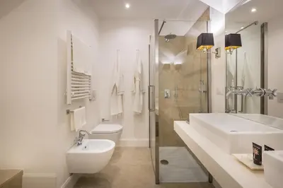 a white bathroom with a sink and a toilet at Old Town Apartments Rome in Rome