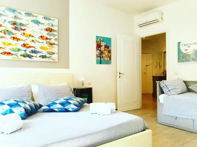 a bedroom with two beds and a painting on the wall at Trastevere Vintage Rosazza in Rome