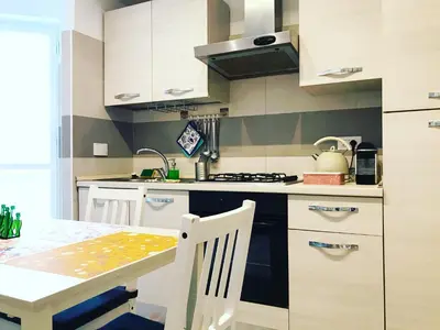 a kitchen with a table and a stove top oven at Trastevere Vintage Rosazza in Rome