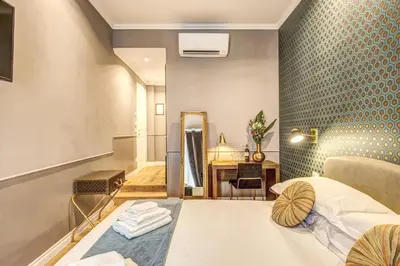 a hotel room with a bed and a mirror at Charme Spagna Boutique Hotel in Rome
