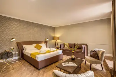a hotel room with a bed and a couch at Charme Spagna Boutique Hotel in Rome
