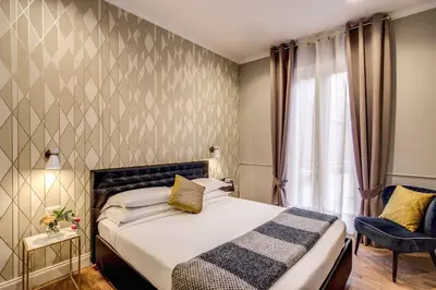 a hotel room with a bed and a window at Charme Spagna Boutique Hotel in Rome