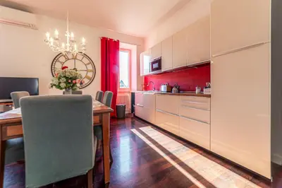 a kitchen with a table and a dining room at Moma Domus - Golden Keys Collection in Rome