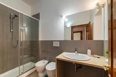 a bathroom with a sink and a shower and a toilet at Casa dell'Arco - WelcomeToRhome in Rome