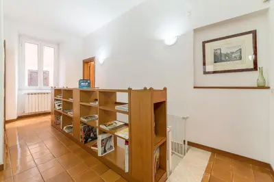 a room with a book shelf with books at Casa dell'Arco - WelcomeToRhome in Rome