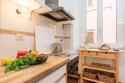 a kitchen with a counter with vegetables on it at Casa dell'Arco - WelcomeToRhome in Rome