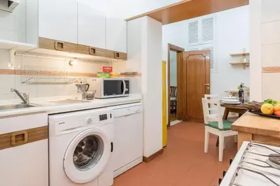 a kitchen with a washing machine and a sink at Casa dell'Arco - WelcomeToRhome in Rome