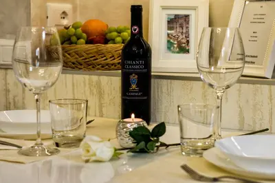 a bottle of wine sitting on a table with glasses at Sweet Life Trevi Roma in Rome