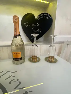 a bottle of champagne and two glasses on a table at Sweet Life Trevi Roma in Rome