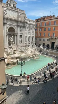 a fountain with green water in front of a building at Sweet Life Trevi Roma in Rome