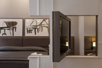 a mirror on a shelf in a living room at Amazing Suite Piazza Venezia in Rome