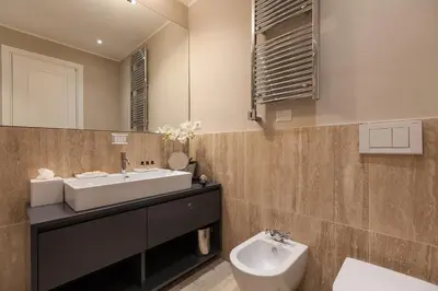 a bathroom with a sink and a toilet and a mirror at Amazing Suite Piazza Venezia in Rome