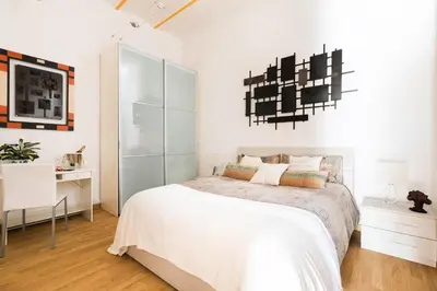 a white bedroom with a bed and a desk at Home Domus Borgo Pio - San Pietro in Rome