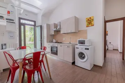a kitchen with a table and a washing machine at Castel Sant Angelo's Harmonious Apartment in Rome