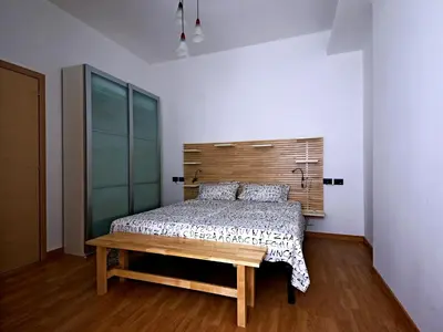a bedroom with a bed with a wooden headboard at Casa Vacanze Shivon in Rome
