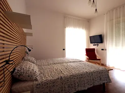 a bedroom with a bed and a window at Casa Vacanze Shivon in Rome