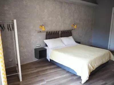 a bedroom with a bed and two lights on the wall at Bed and Breakfast New Morning Holiday in Rome