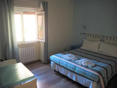 a bedroom with a bed with two towels on it at Bed and Breakfast New Morning Holiday in Rome