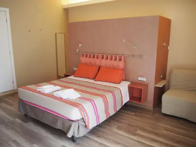 a bedroom with a large bed with orange pillows at Bed and Breakfast New Morning Holiday in Rome