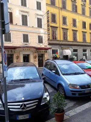 two cars parked next to each other on a street at Oscar Rooms in Rome
