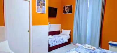 a small room with two beds and a mirror at Oscar Rooms in Rome