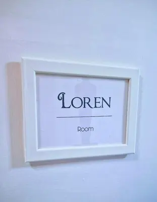 a white frame on a wall with the word room at Oscar Rooms in Rome