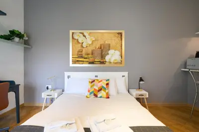 a bedroom with a bed and a painting on the wall at Studio via Nicola Fabrizi in Rome