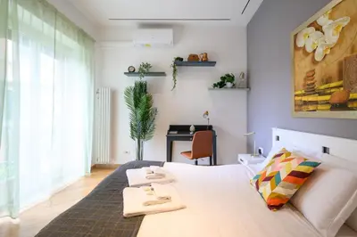a bedroom with a bed and a desk in it at Studio via Nicola Fabrizi in Rome