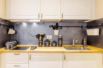 a kitchen with white cabinets and a sink at Trans Tiberim in Rome