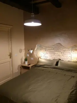 a bedroom with a bed and a brick wall at Trans Tiberim in Rome