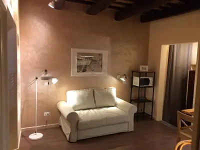a living room with a white couch and a lamp at Trans Tiberim in Rome