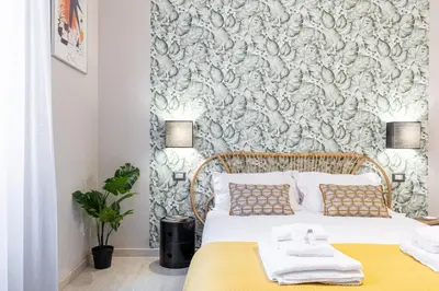a bedroom with a bed with a wall mural at Rome as you feel - Diocleziano Apartment in Rome
