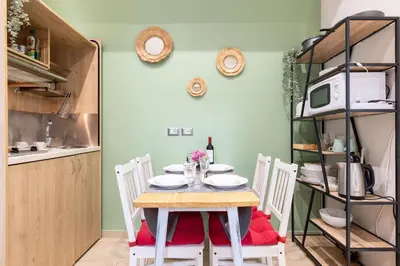a dining room with a table and four chairs at Rome as you feel - Diocleziano Apartment in Rome