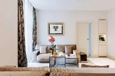 a living room with a couch and a table at Aleph Rome Hotel, Curio Collection By Hilton in Rome