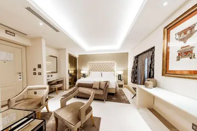 a hotel room with a bed and a desk at Aleph Rome Hotel, Curio Collection By Hilton in Rome