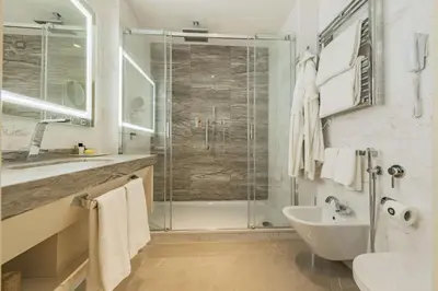 a bathroom with a shower and a sink at Aleph Rome Hotel, Curio Collection By Hilton in Rome