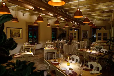 a dining room with tables and chairs and lights at Aleph Rome Hotel, Curio Collection By Hilton in Rome