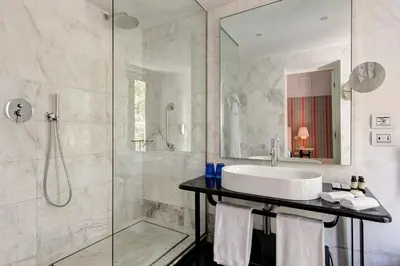 a bathroom with a sink and a shower at Grand Hotel Palace Rome in Rome
