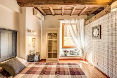 a bedroom with a bed and a window at Pantheon Miracle Suite in Rome
