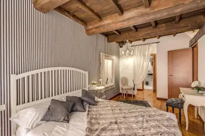 a bedroom with a bed and a table and a desk at Pantheon Miracle Suite in Rome