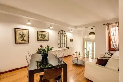 a living room with a table and a couch at Pantheon Miracle Suite in Rome